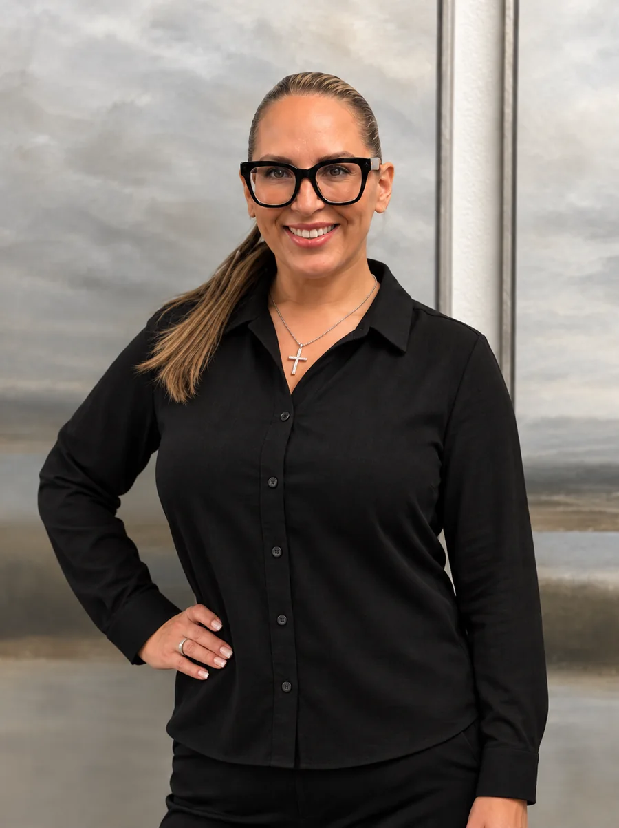 Heather smiling in a black blouse and glasses